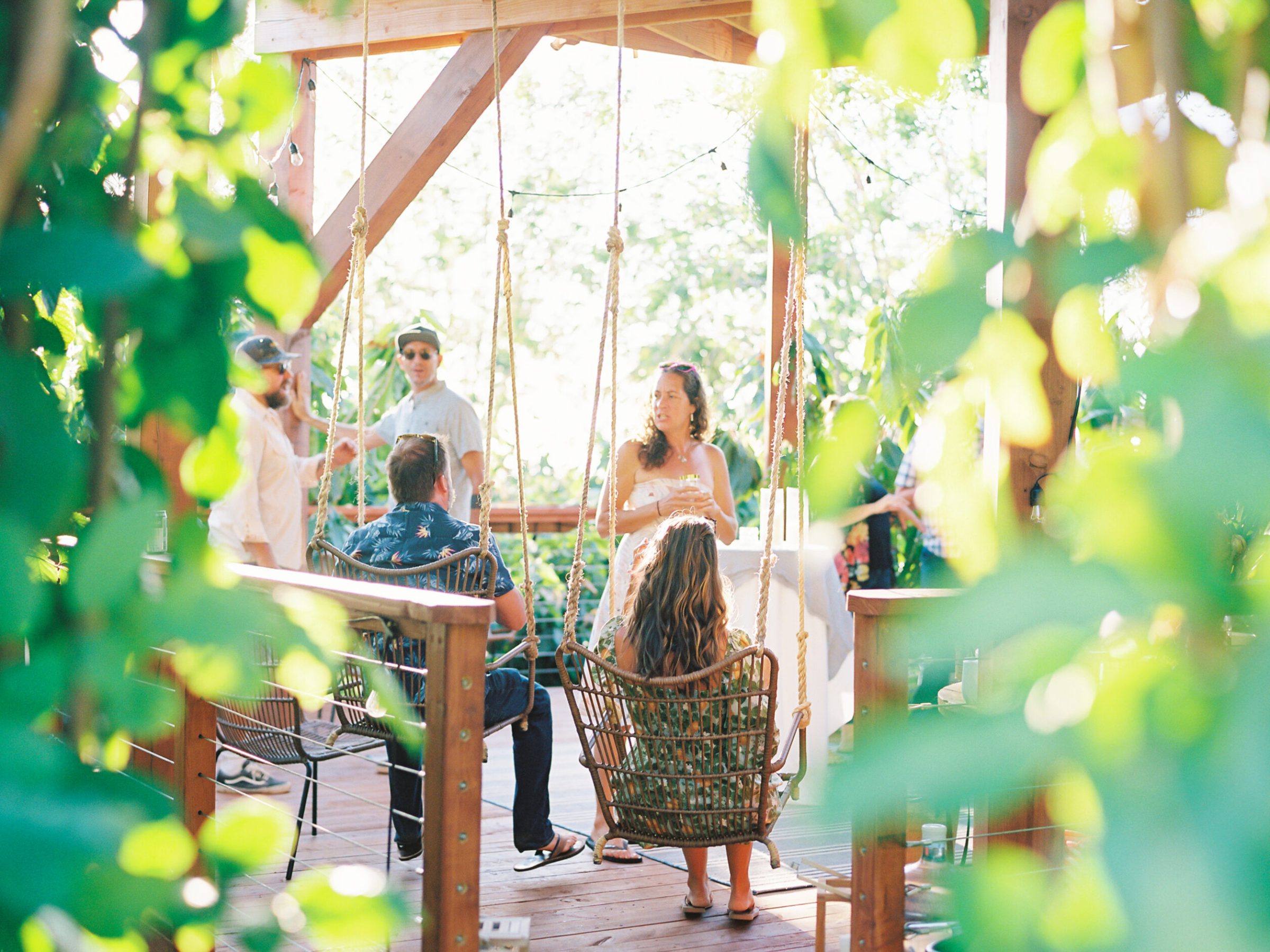 a person sitting at a table with a vase of flowers