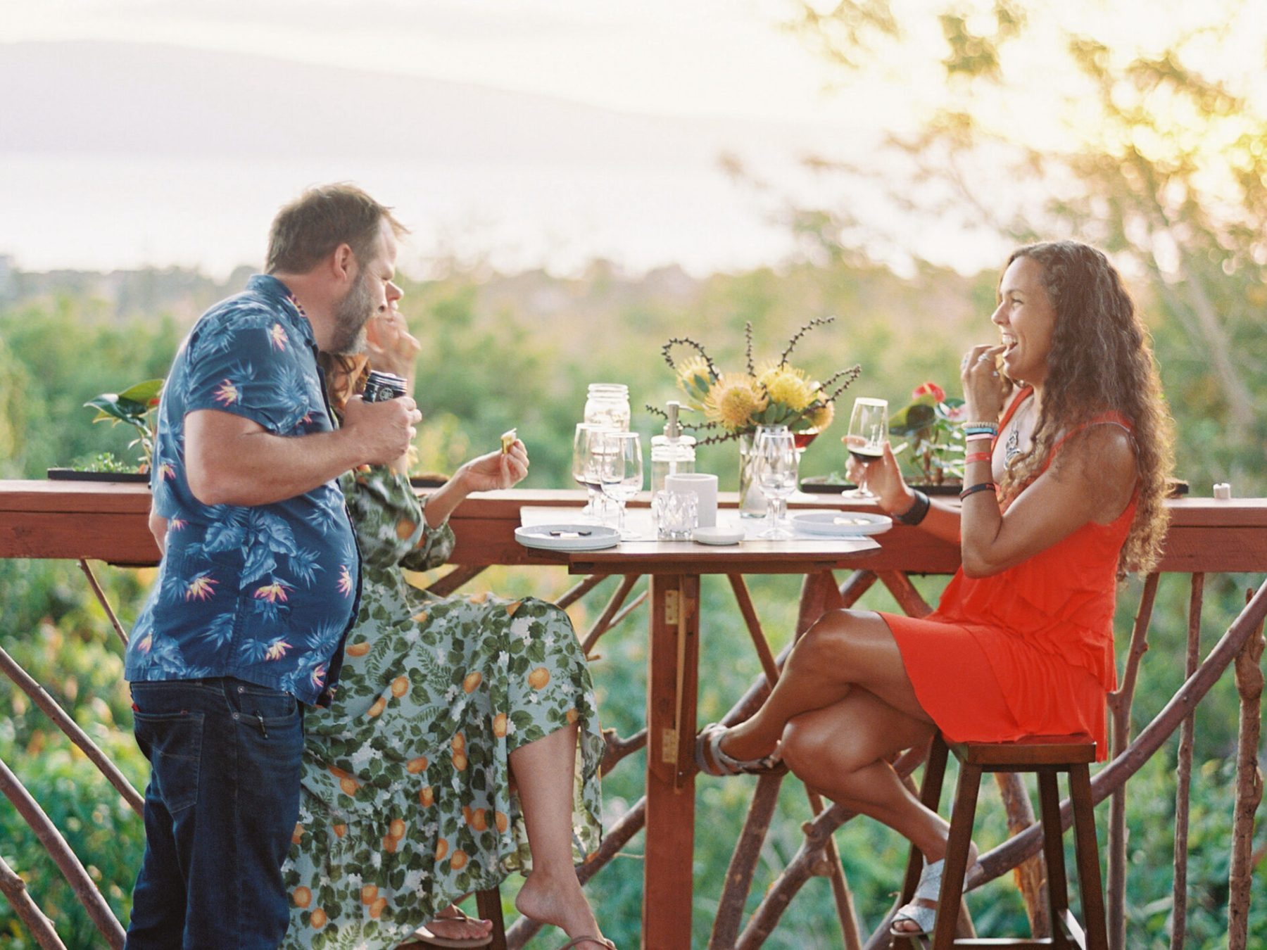a group of people sitting around a wooden table