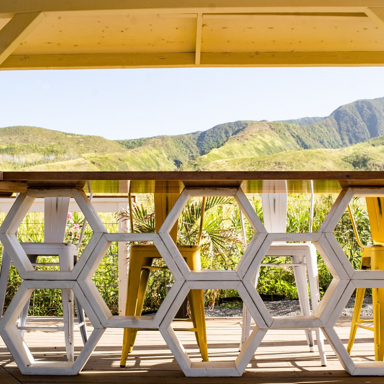 a close up of a seating area with mountains in the background
