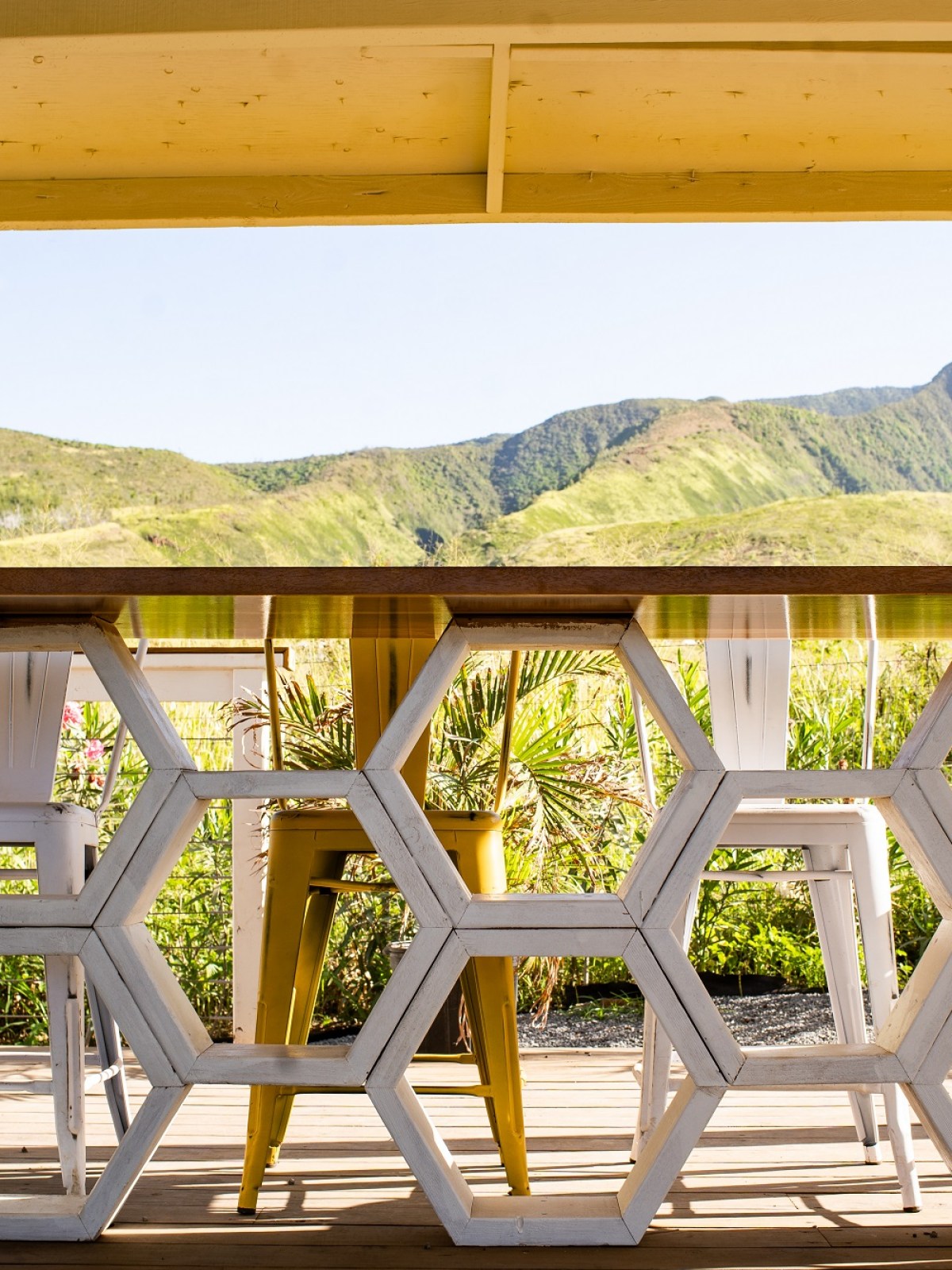 a close up of a seating area with mountains in the background