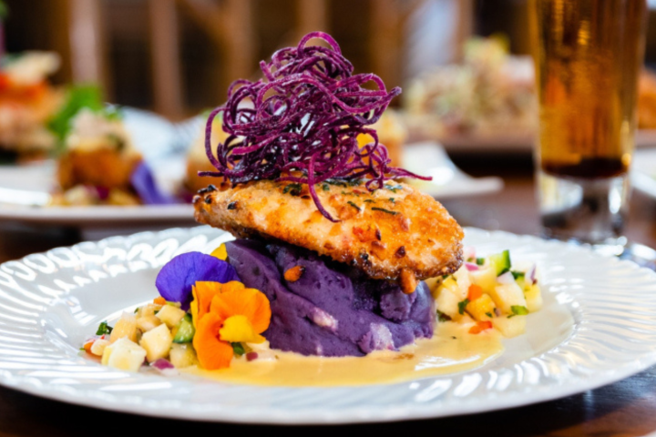 a close up of a plate of food and a glass of wine